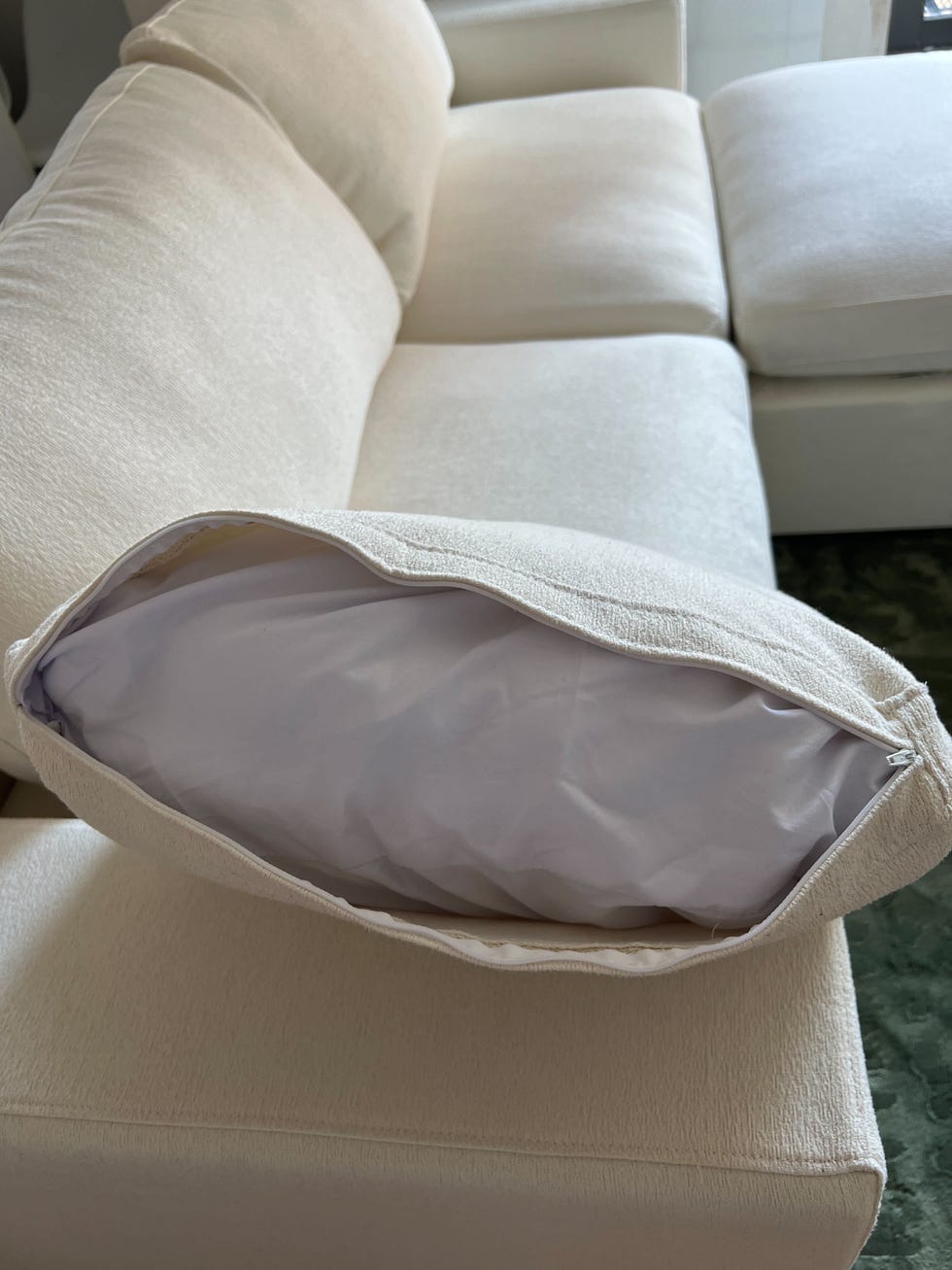 a white couch with a cushion
